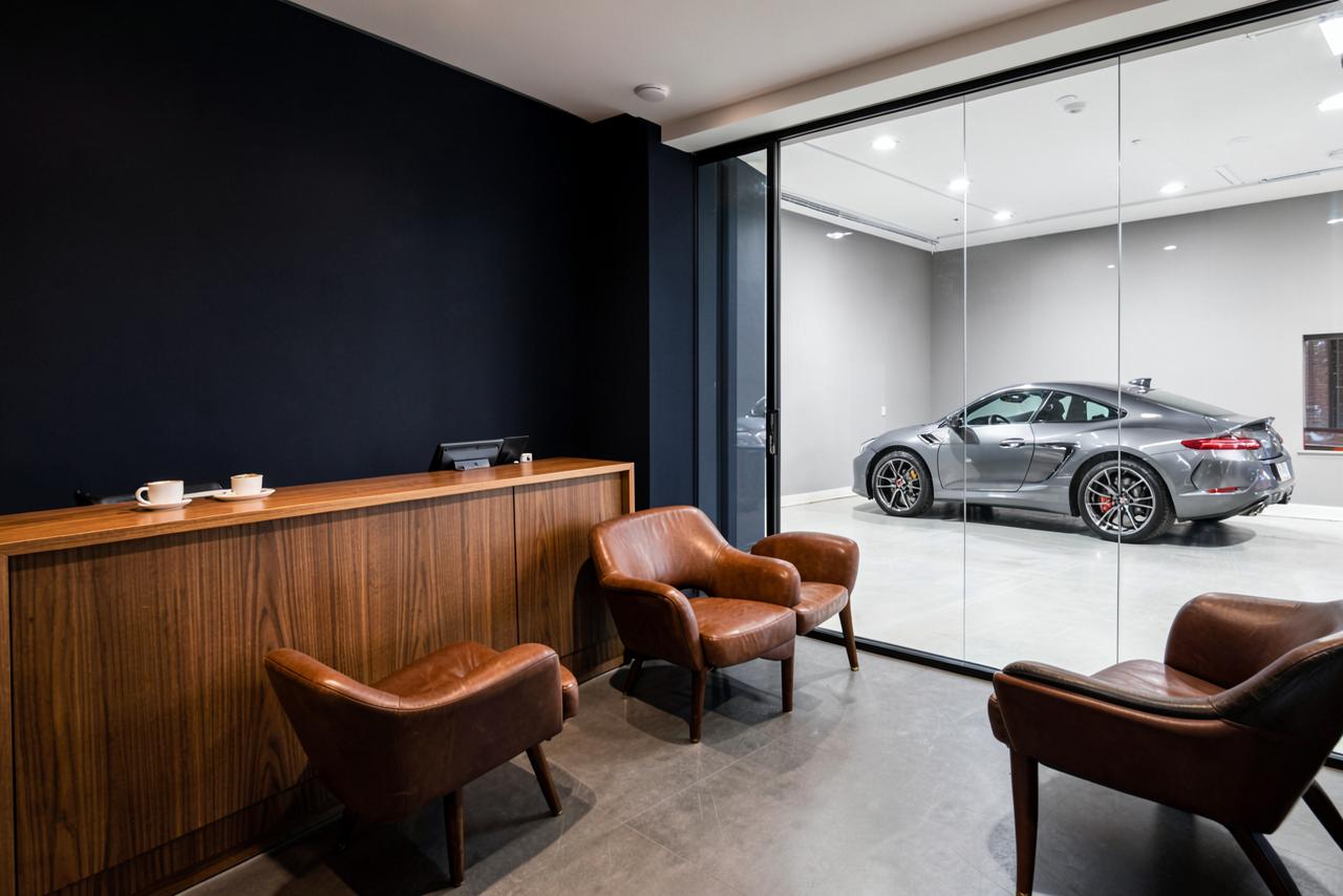 A premium detailing studio reception lounge with seating and a coffee bar